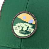 Green hat with patch depicting two people fishing