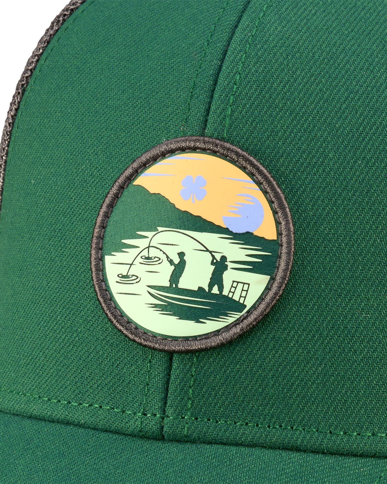 Green hat with patch depicting two people fishing