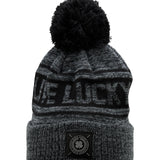 "Lucky Baller" beanie from Black Clover featuring, a black striped design, a cuff, and fluffy black pom-pom on top