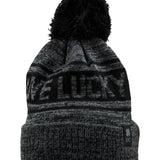 "Lucky Baller" beanie from Black Clover featuring, a black striped design, a cuff, and fluffy black pom-pom on top