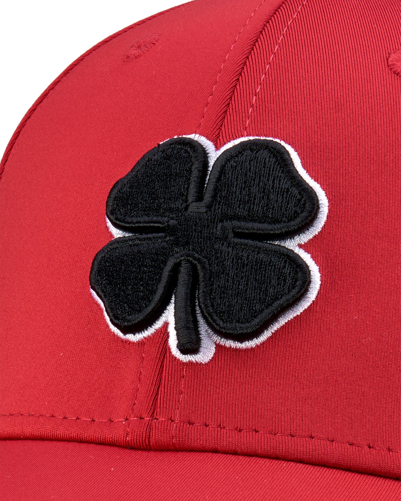 Bold, red hat from Black Clover featuring premium style and craftmanship. It features an embroidered black clover icon, and the words "Live Lucky" on the side.