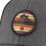 Grey hat with patch depicting vehicle offroad