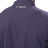 Man wearing navy polo from Black Clover with a small clover near the buttons