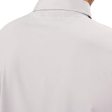 Man wearing light grey polo from Black Clover with a small clover near the buttons