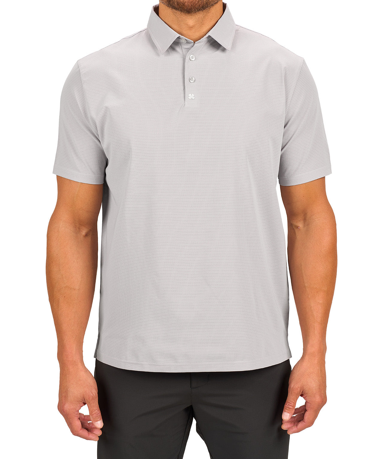 Man wearing light grey polo from Black Clover with a small clover near the buttons