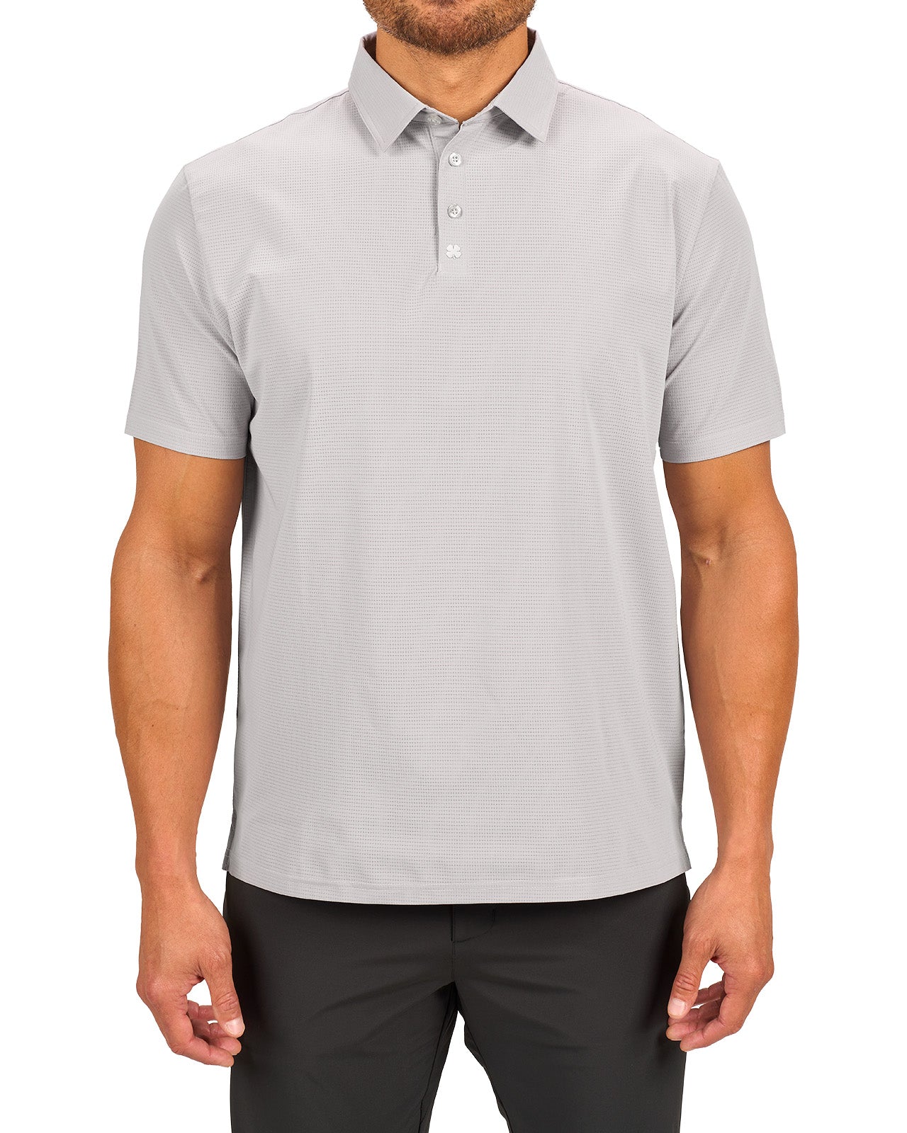 Man wearing light grey polo from Black Clover with a small clover near the buttons