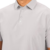 Man wearing light grey polo from Black Clover with a small clover near the buttons