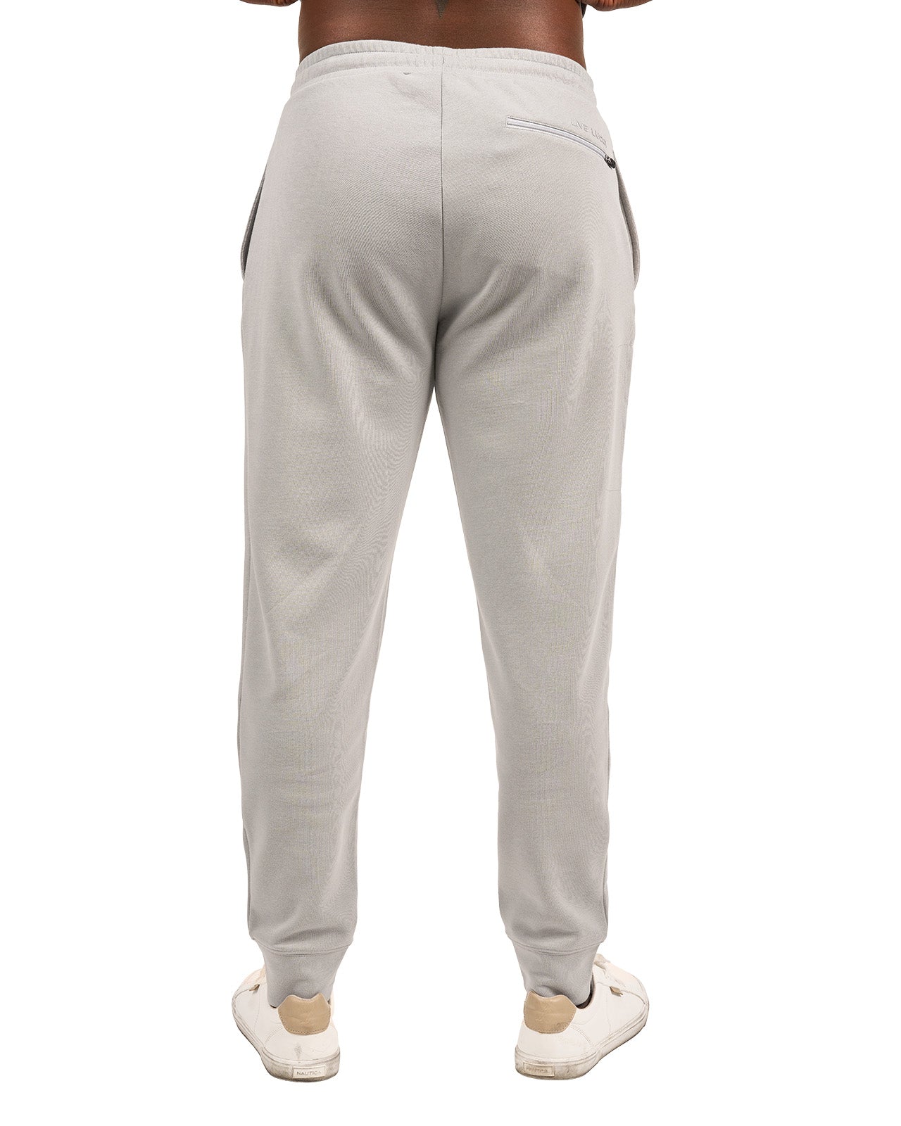 Man wearing light grey sweat pants joggers from black clover