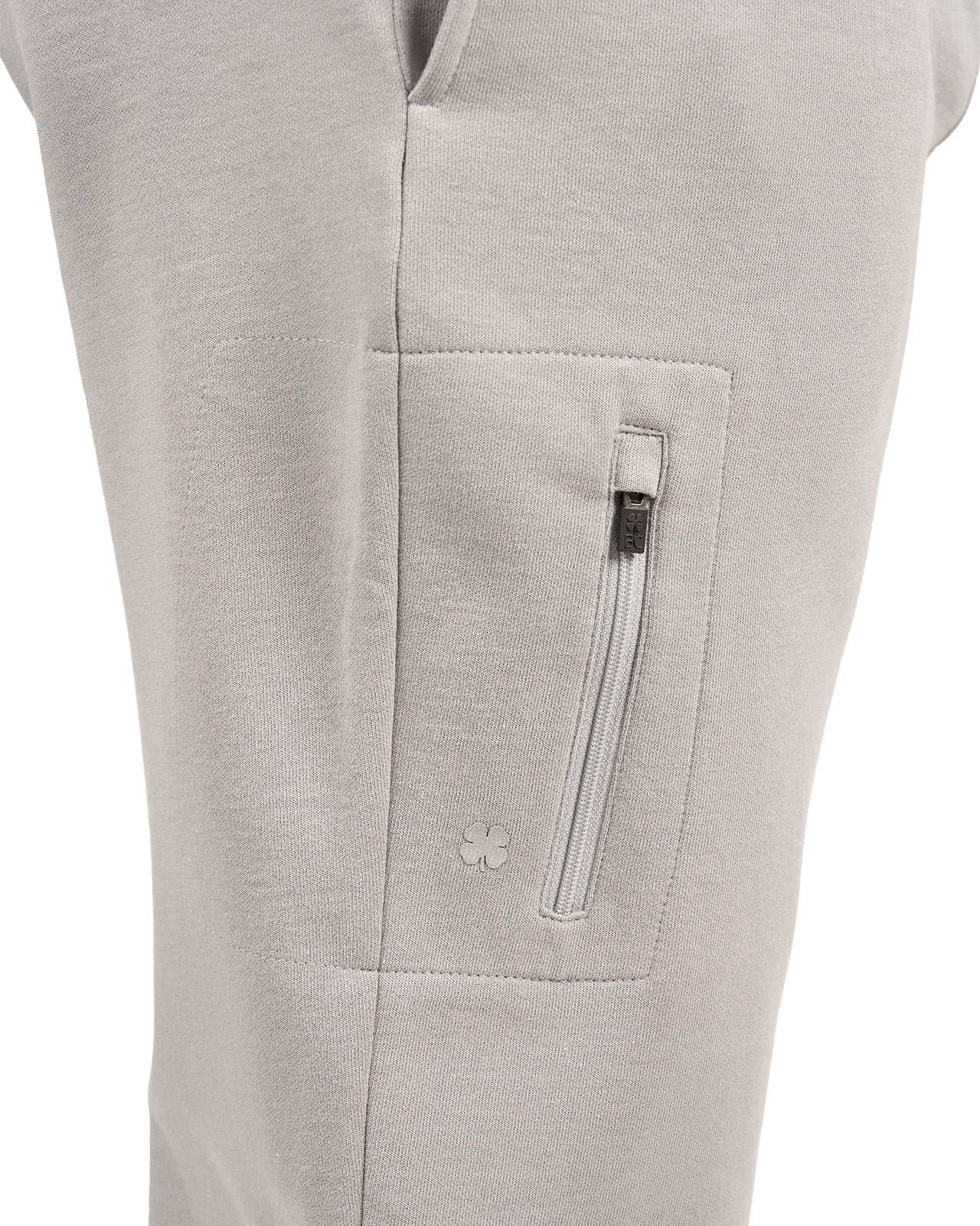 Man wearing light grey sweat pants joggers from black clover