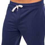 Man wearing navy sweat pants joggers from black clover