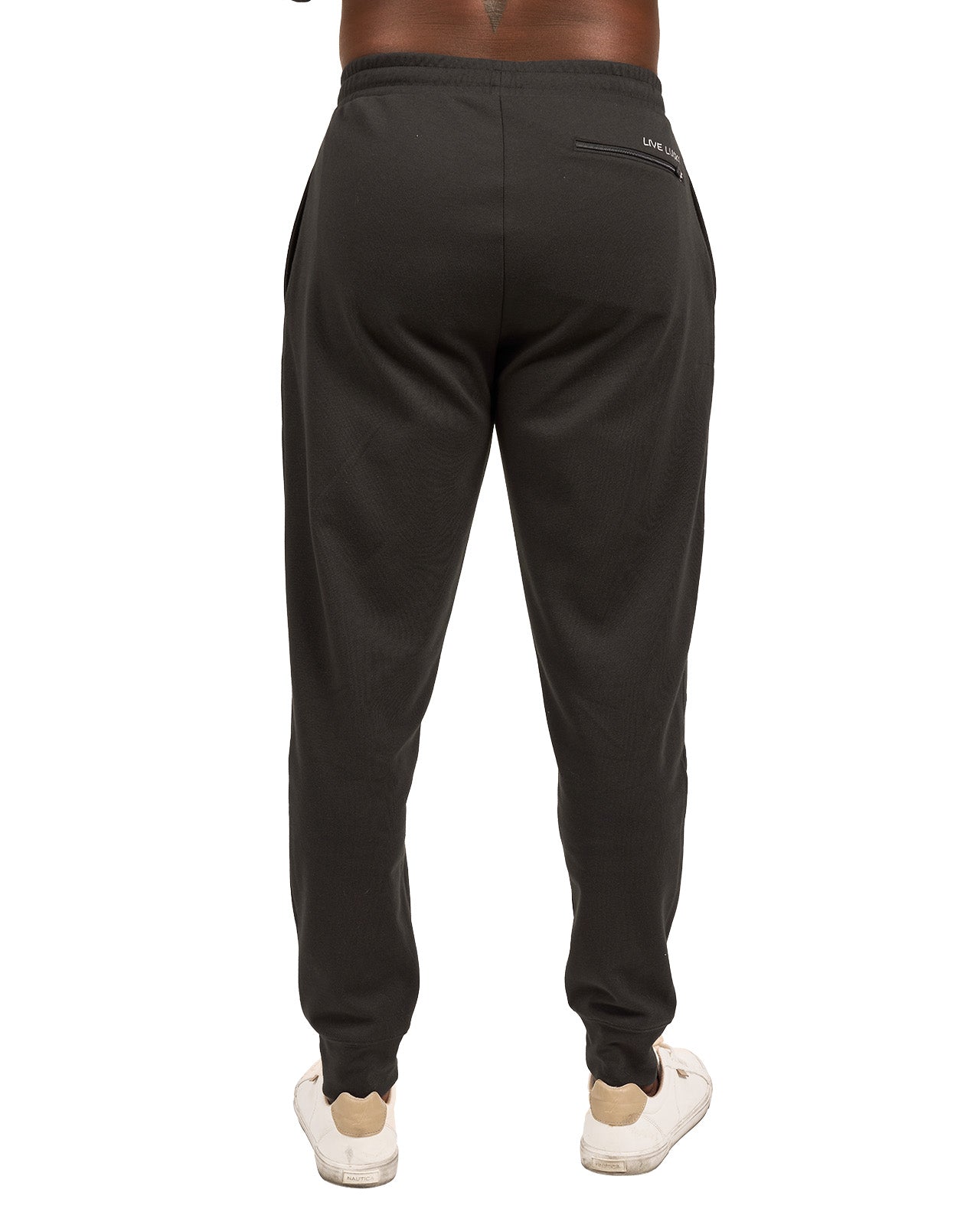 Man wearing black sweat pants joggers from black clover