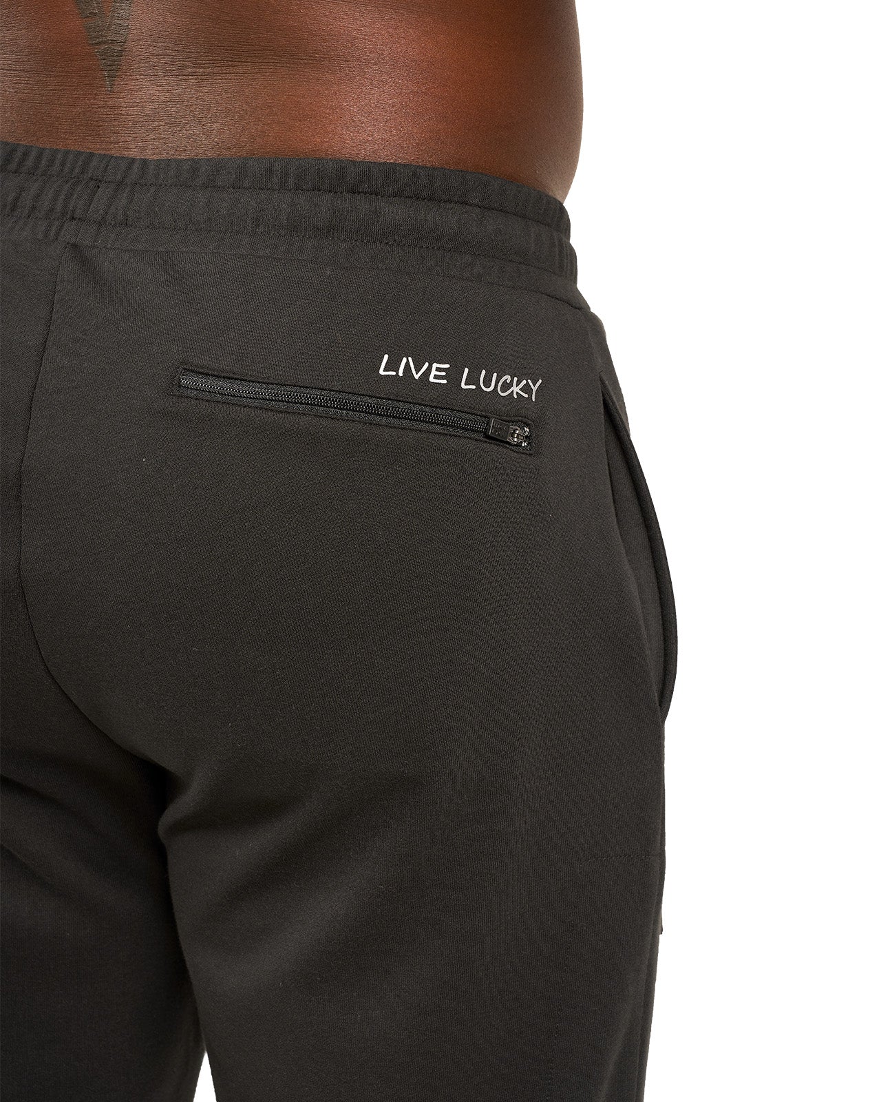 Man wearing black sweat pants joggers from black clover