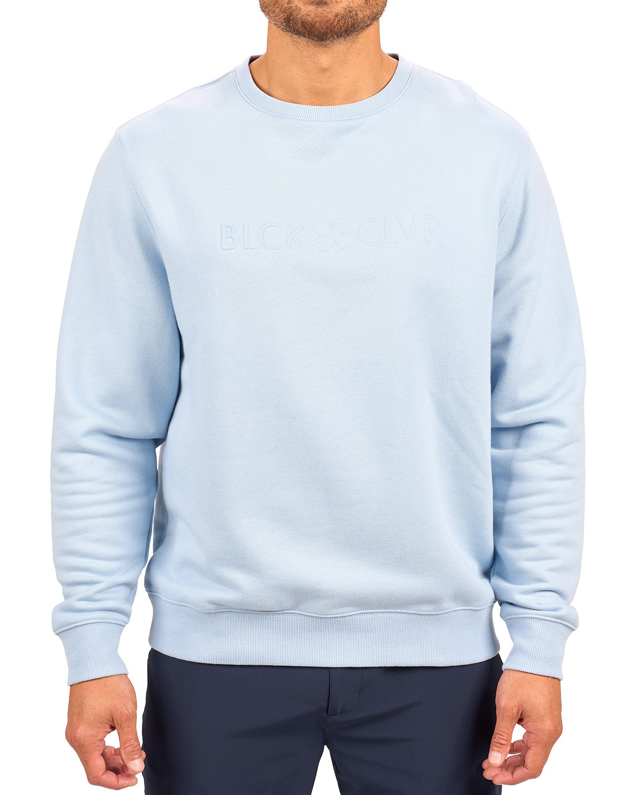 man wearing an light blue colored sweater from Black Clover with a 3d text BLCK CLVR on the chest