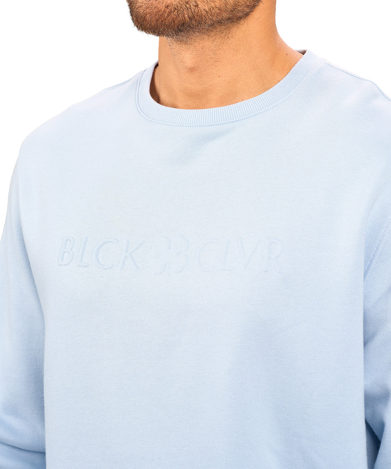 man wearing an light blue colored sweater from Black Clover with a 3d text BLCK CLVR on the chest