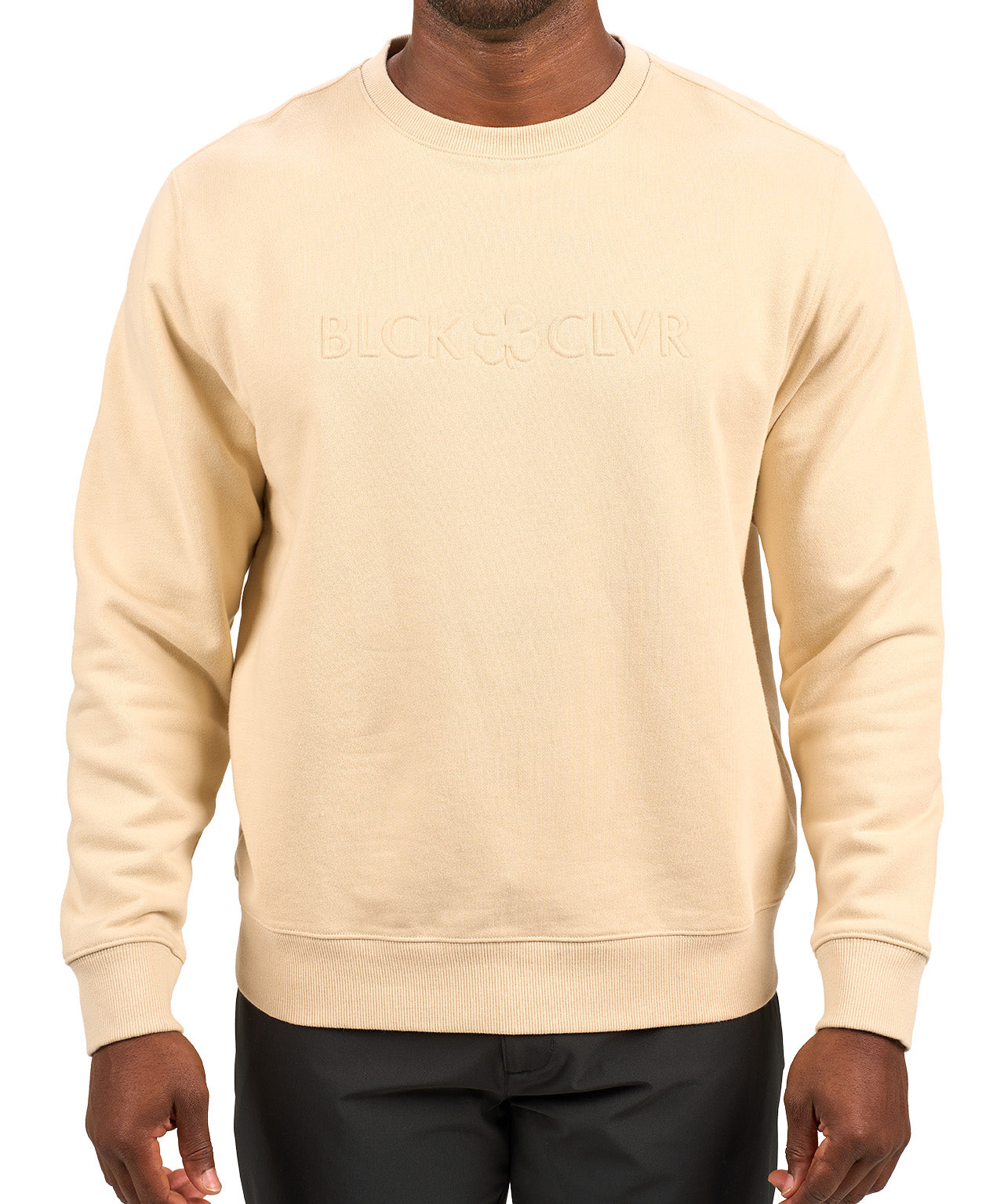 man wearing an oatmeal colored sweater from Black Clover with a 3d text BLCK CLVR on the chest