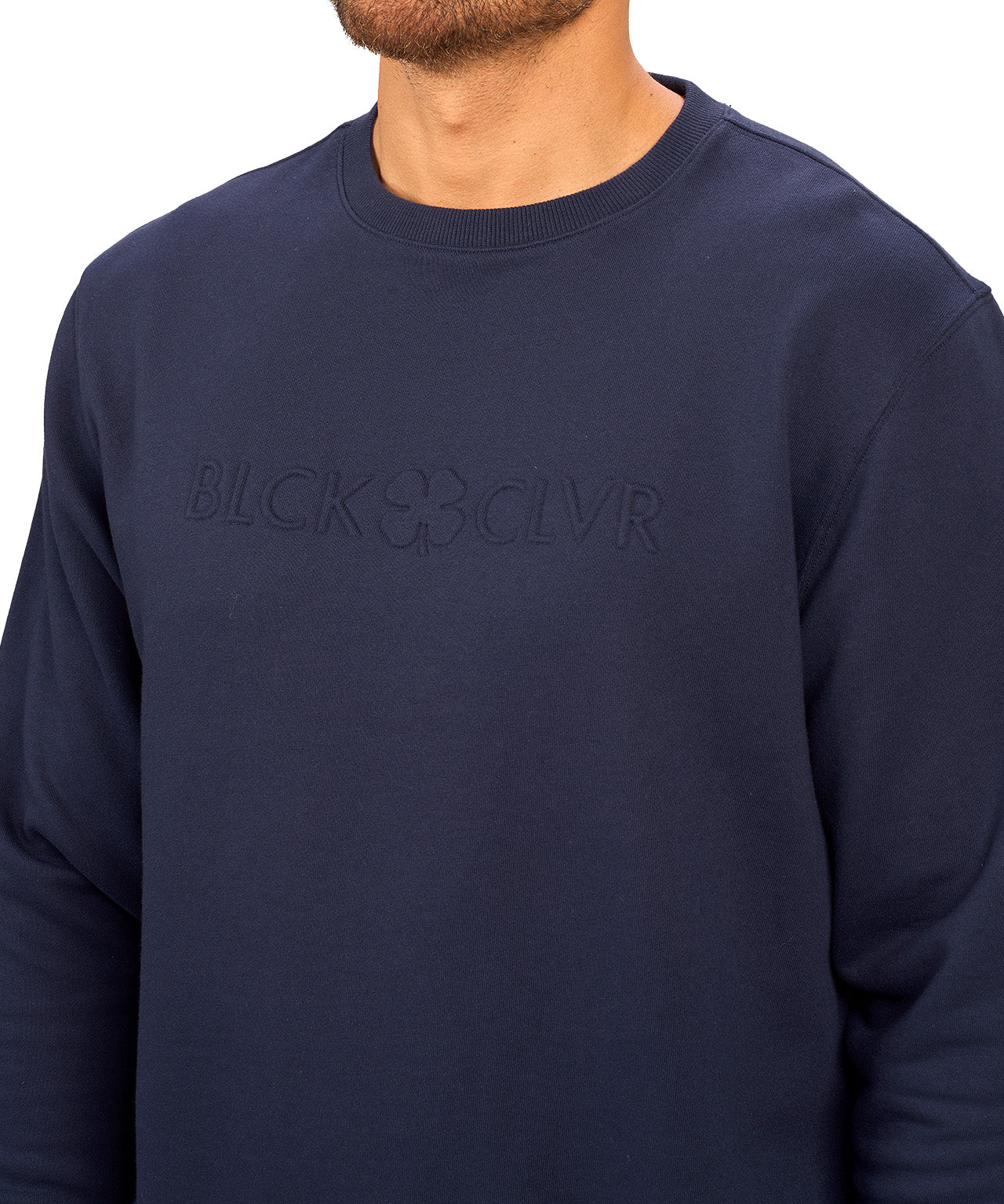 man wearing an navy colored sweater from Black Clover with a 3d text BLCK CLVR on the chest