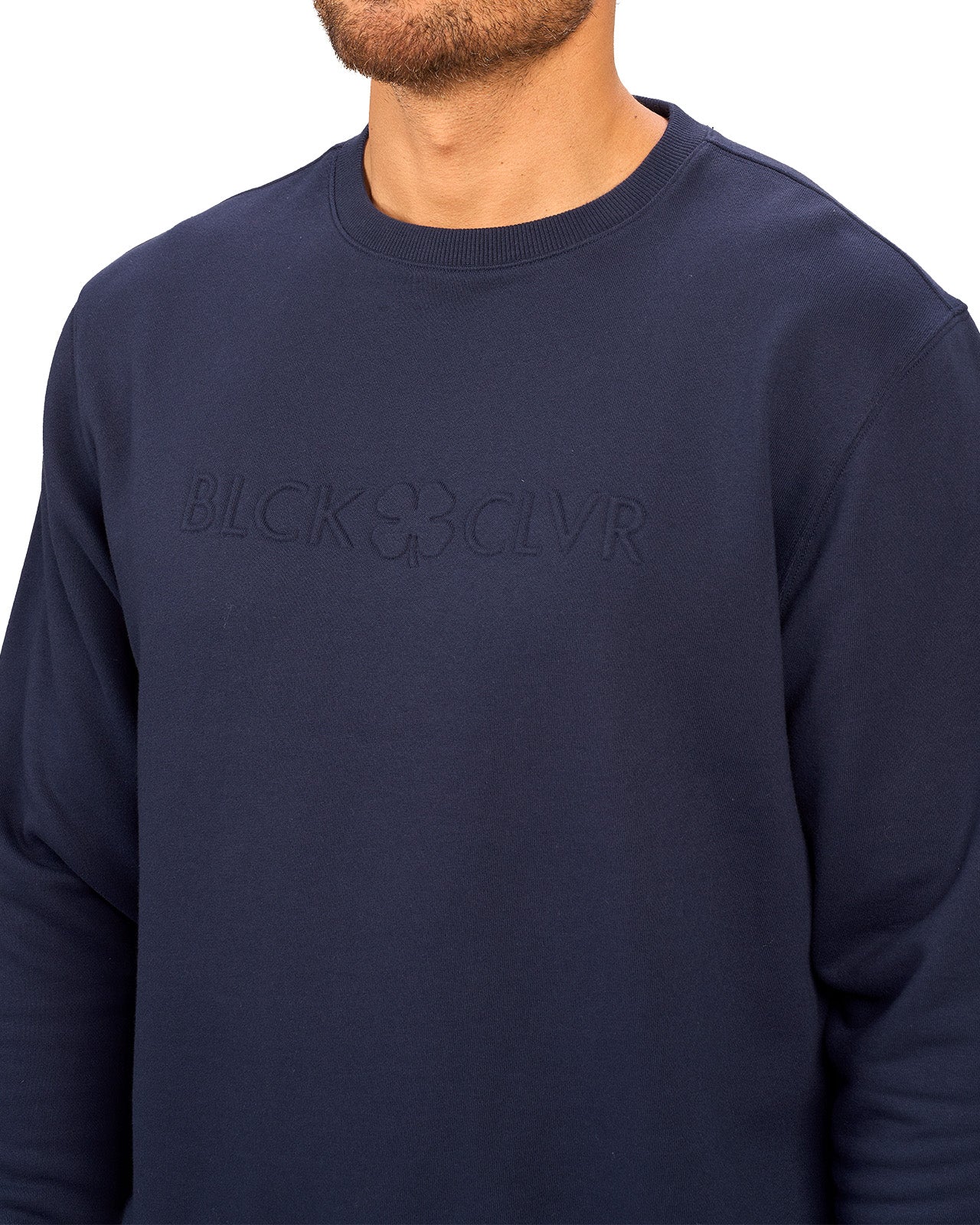 man wearing an navy colored sweater from Black Clover with a 3d text BLCK CLVR on the chest