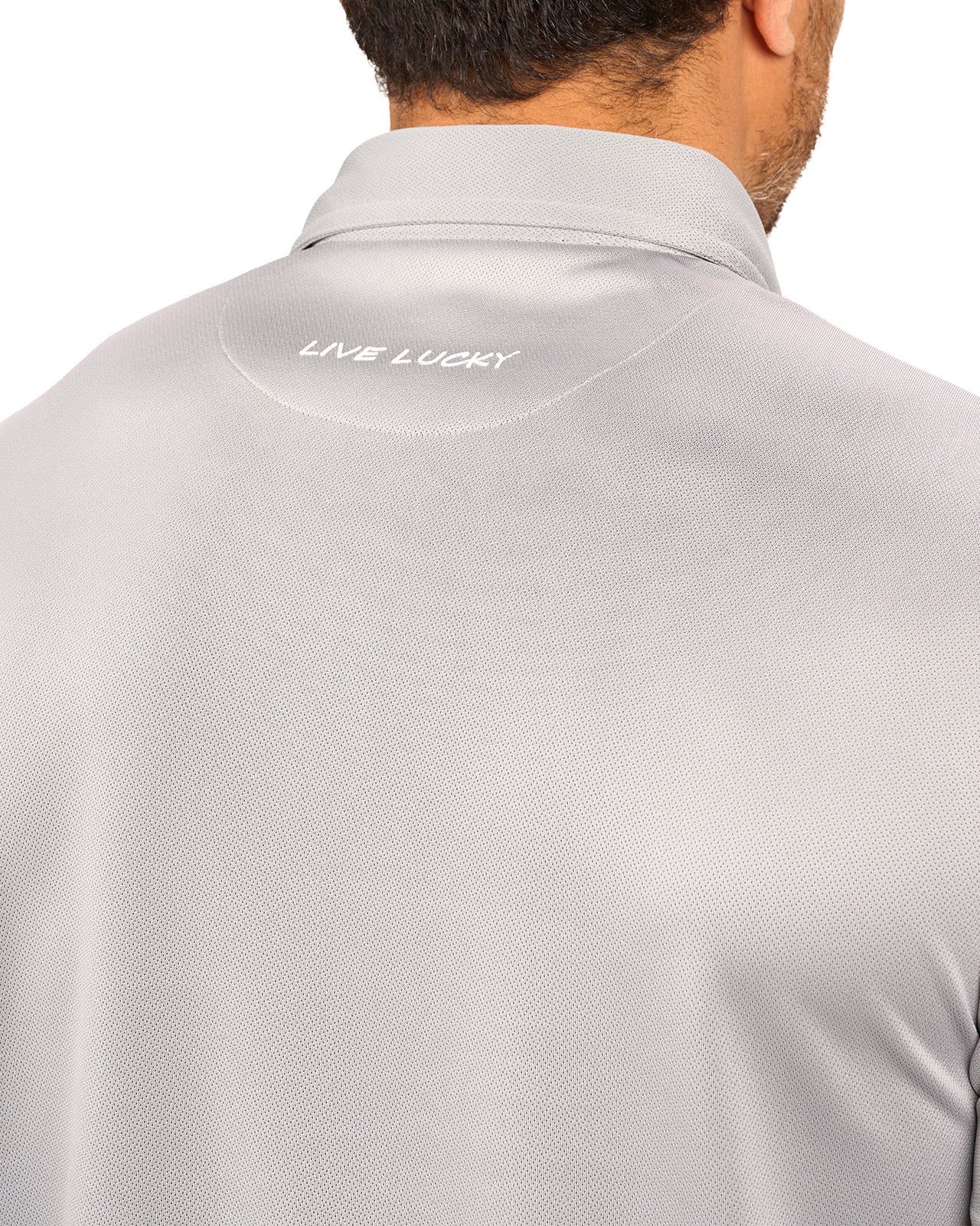 Man wearing a light grey polo from Black Clover with a small BC logo on the left chest