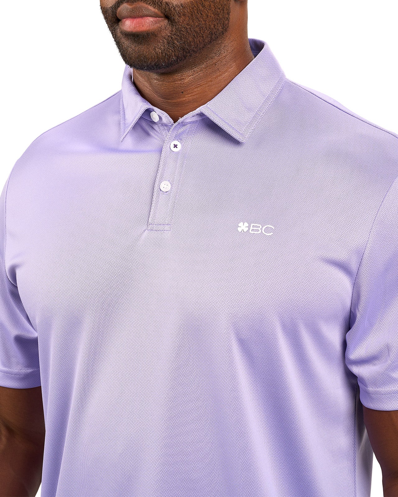 Man wearing a light purple polo from Black Clover with a small BC logo on the left chest