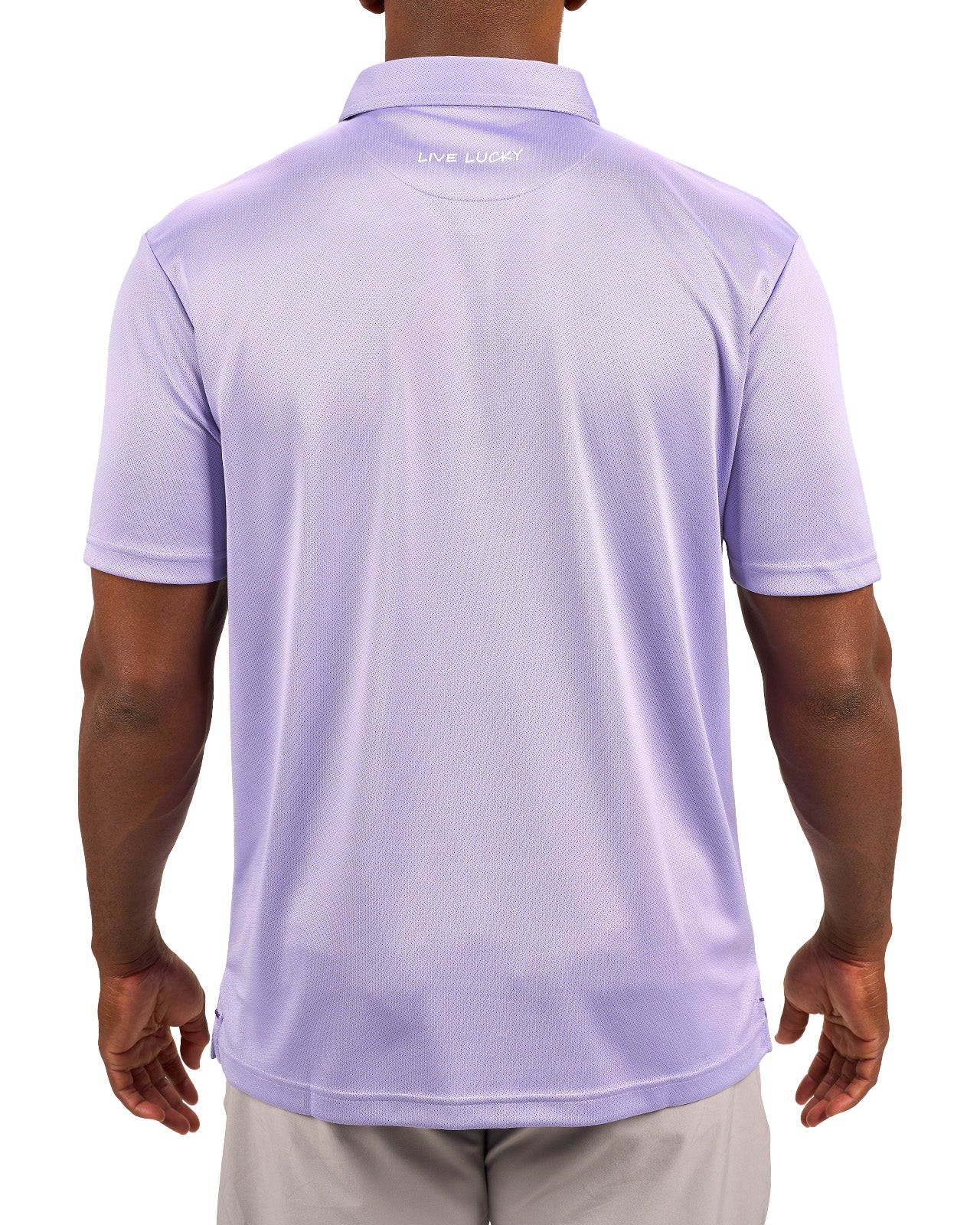 Man wearing a light purple polo from Black Clover with a small BC logo on the left chest