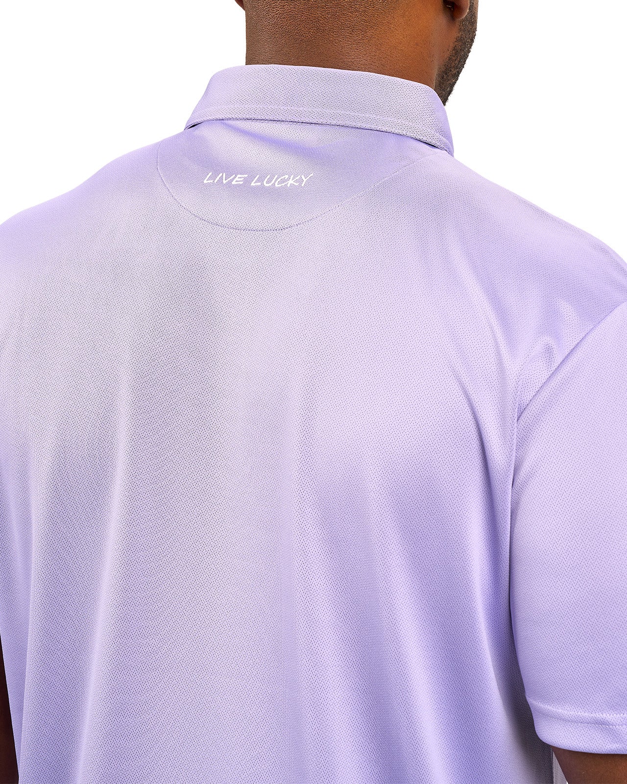 Man wearing a light purple polo from Black Clover with a small BC logo on the left chest