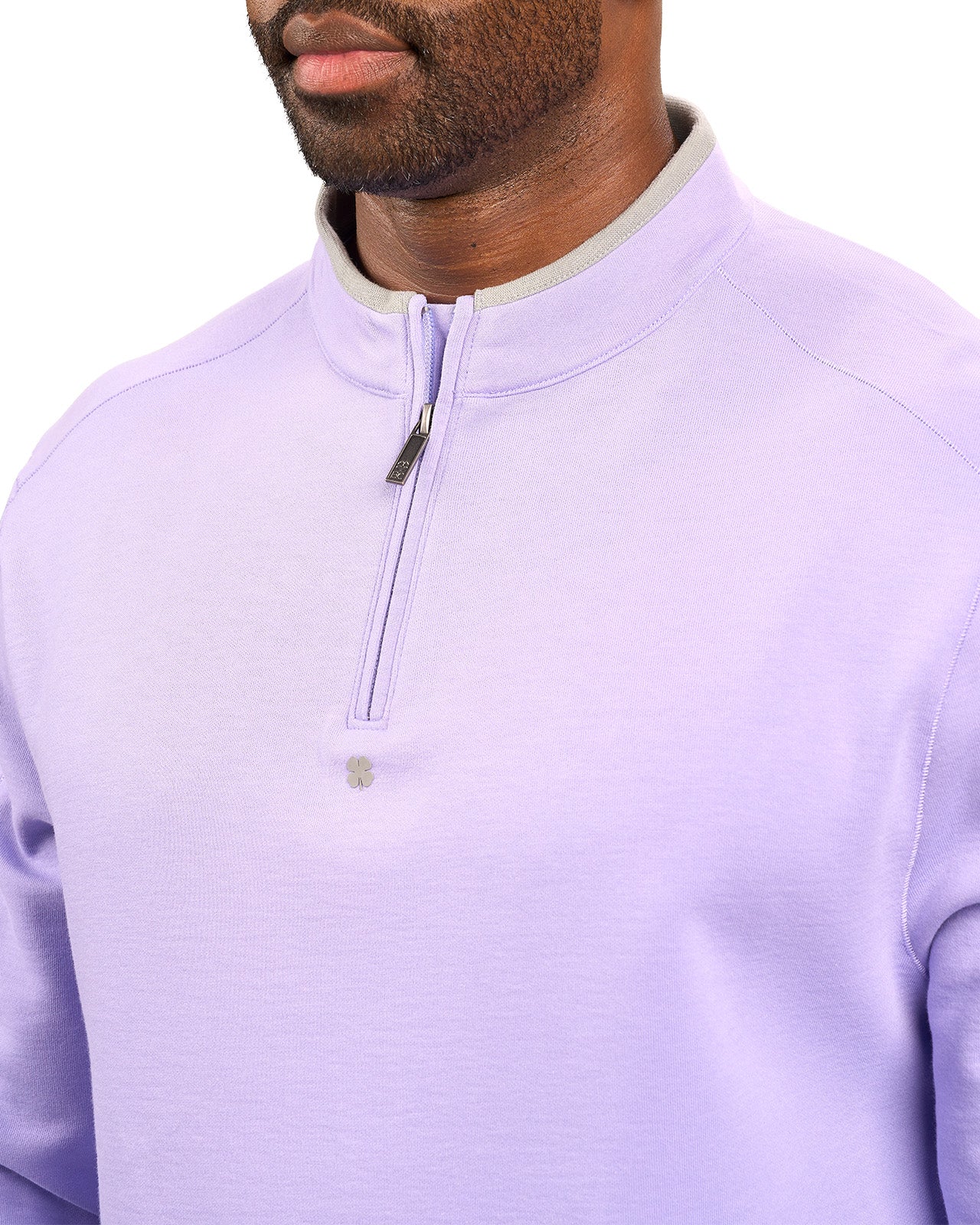 Man wearing a light purple quarter zip sweater from Black Clover featuring a small clover below the zipper