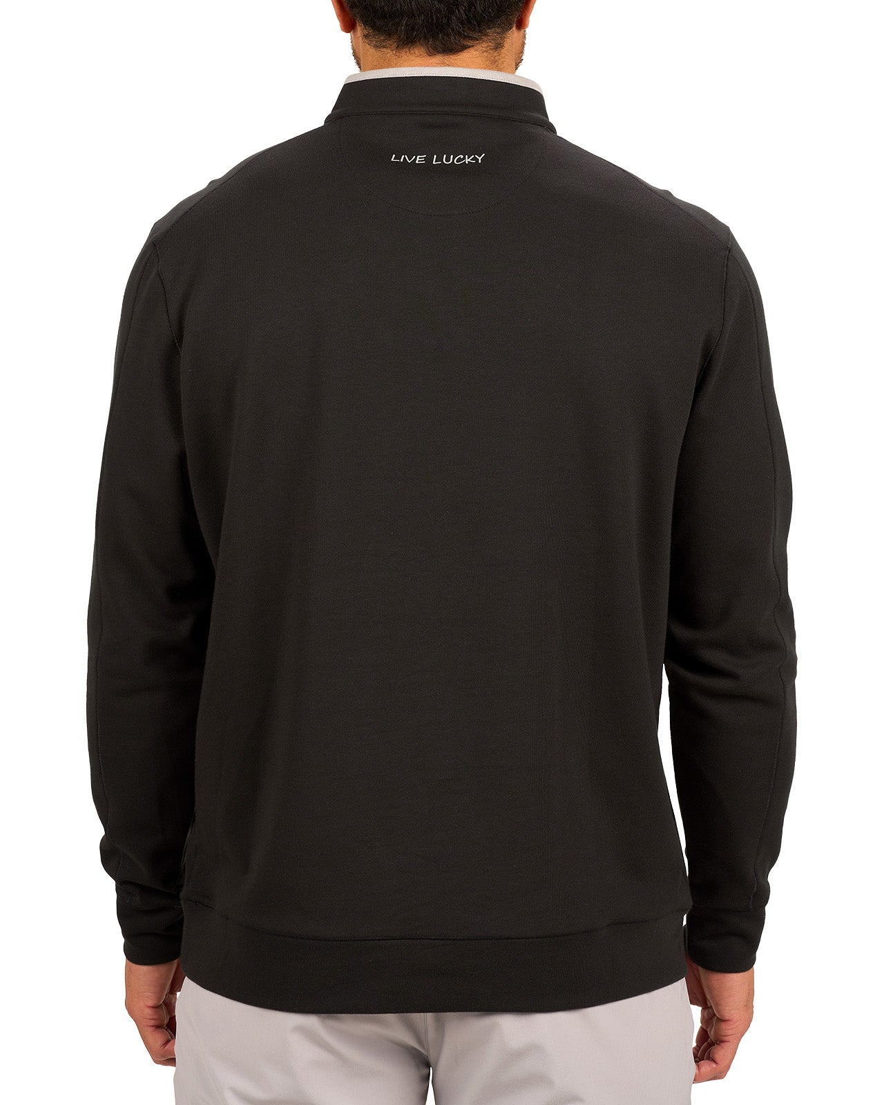 Man wearing a black quarter zip sweater from Black Clover featuring a small clover below the zipper