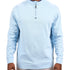 Man wearing a light blue quarter zip sweater from Black Clover featuring a small clover below the zipper