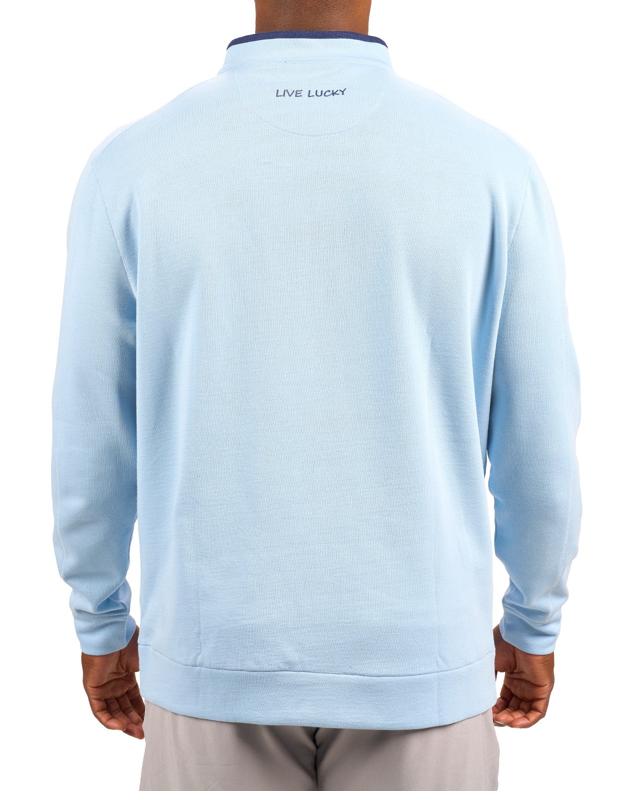 Man wearing a light blue quarter zip sweater from Black Clover featuring a small clover below the zipper