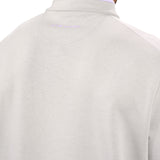 Man wearing a light grey quarter zip sweater from Black Clover featuring a small clover below the zipper