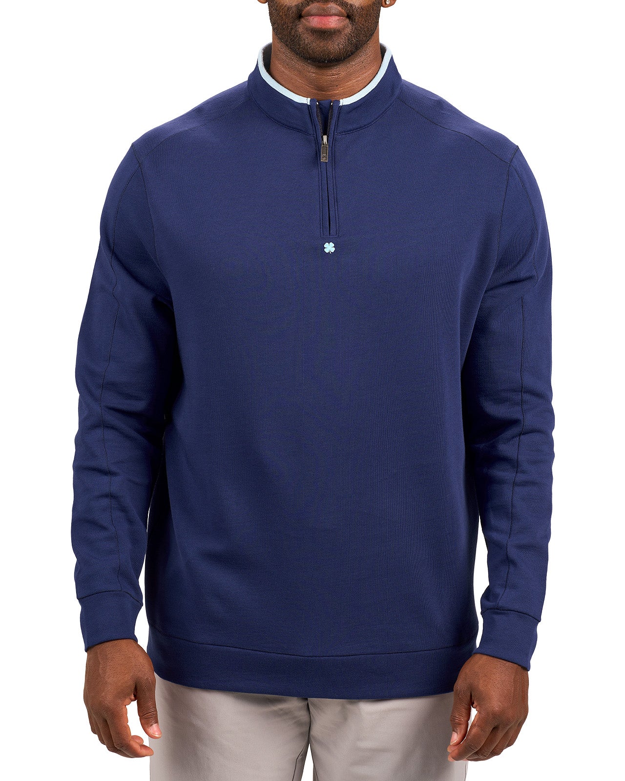 Man wearing a navy quarter zip sweater from Black Clover featuring a small clover below the zipper