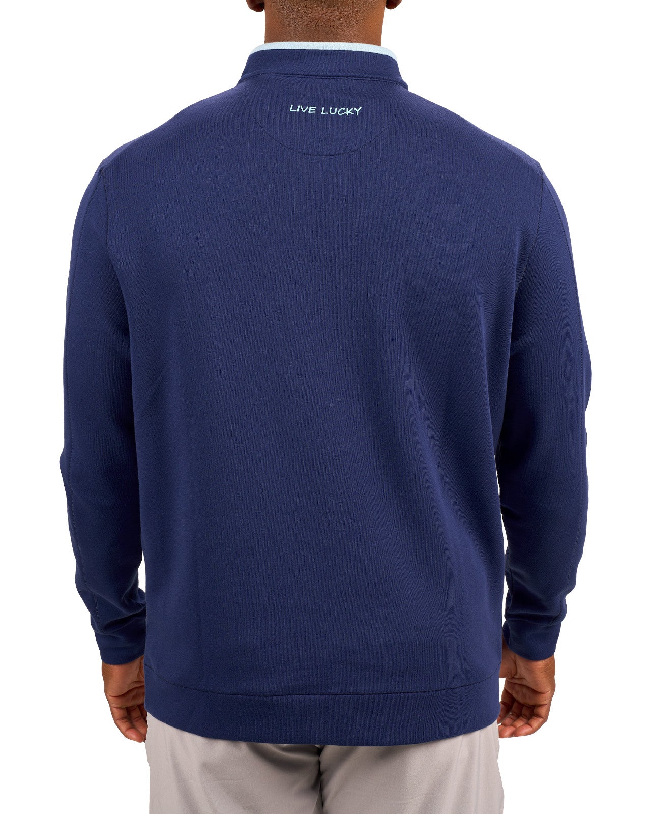 Man wearing a navy quarter zip sweater from Black Clover featuring a small clover below the zipper