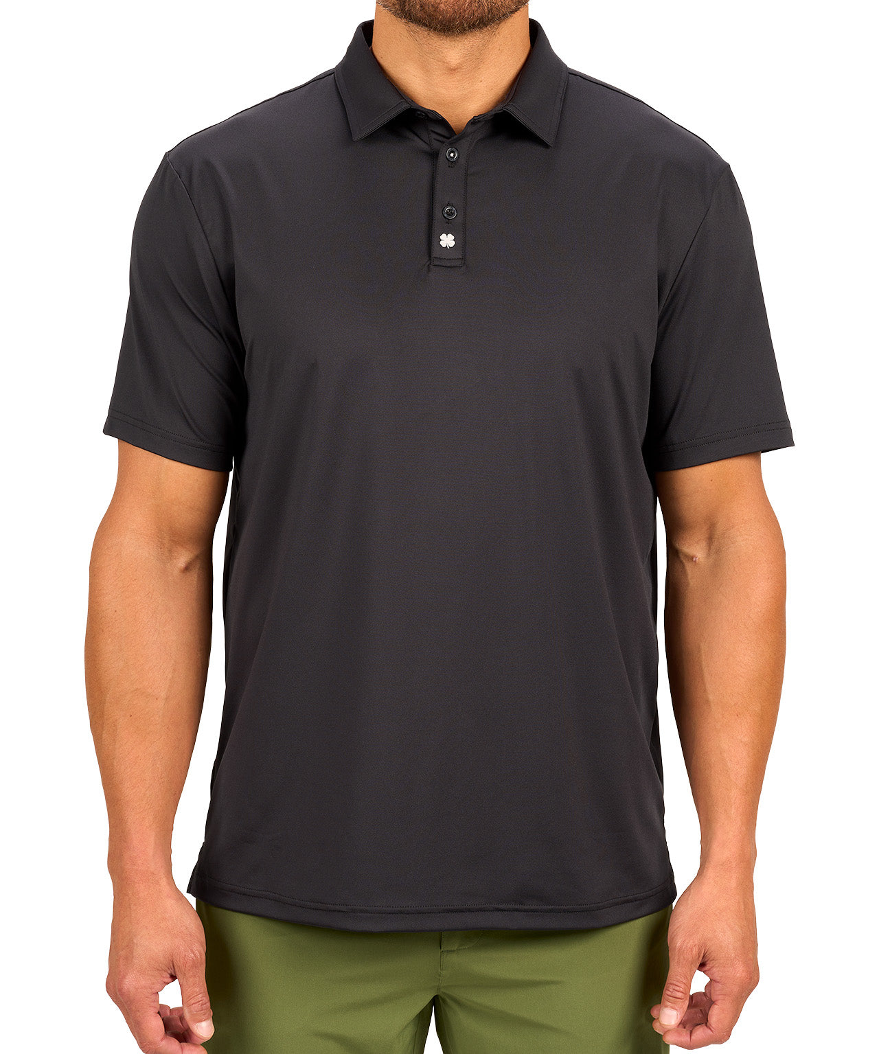 Man wearing black polo from black clover featuring a small clover logo below the bottom button