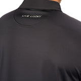 Man wearing black polo from black clover featuring a small clover logo below the bottom button