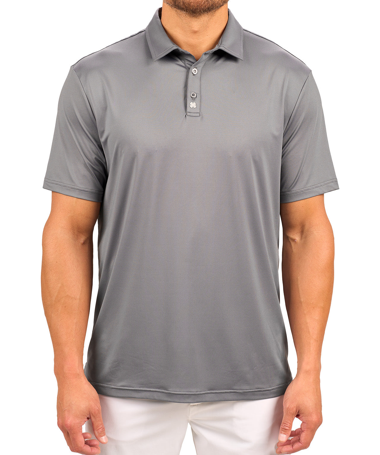 Man wearing charcoal grey polo from black clover featuring a small clover logo below the bottom button