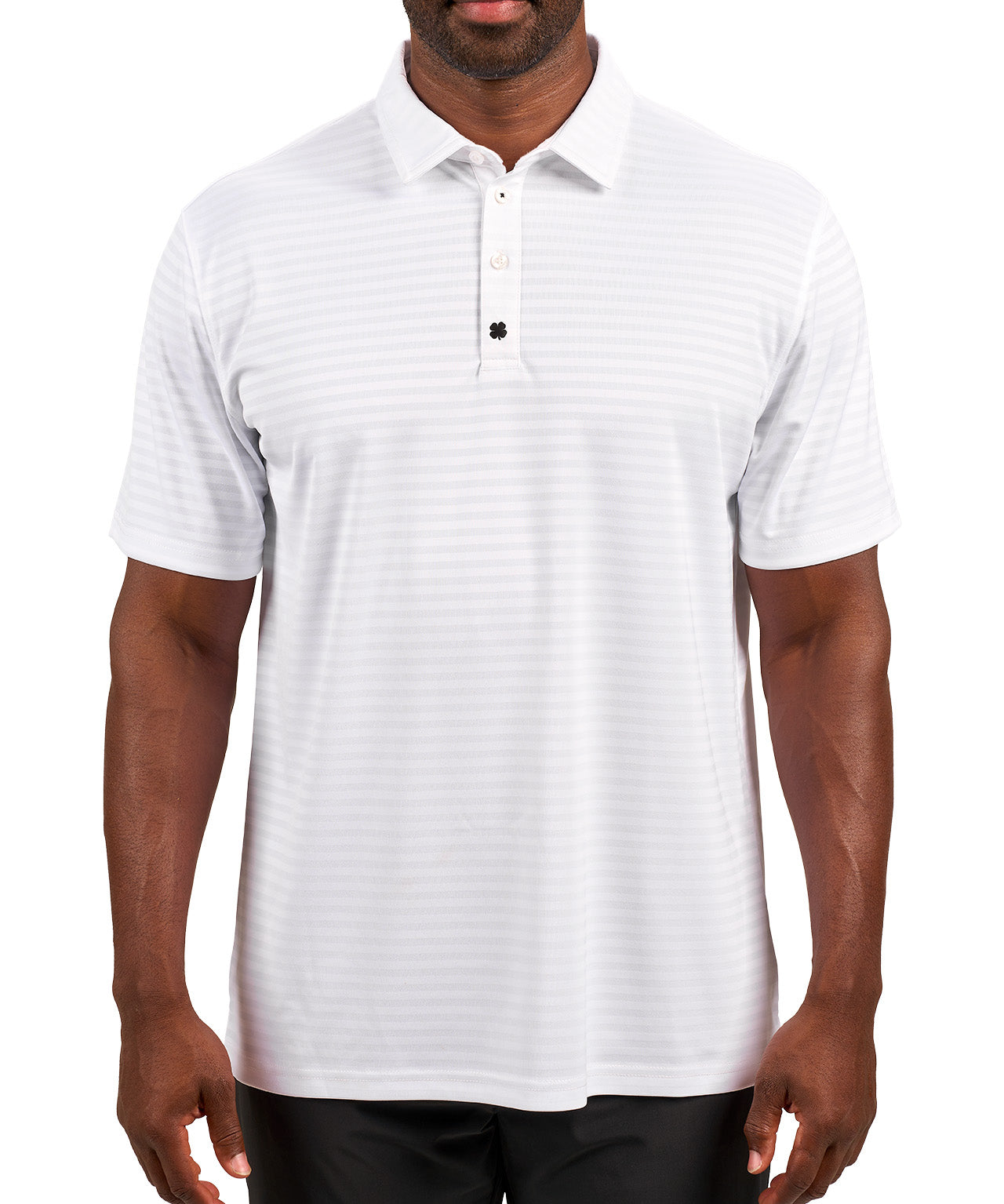 Man wearing striped white polo from Black Clover featuring small clover logo below the bottom button