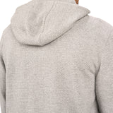 Man wearing oatmeal colored zip up hoodie from Black Clover featuring small clover icon on the left chest