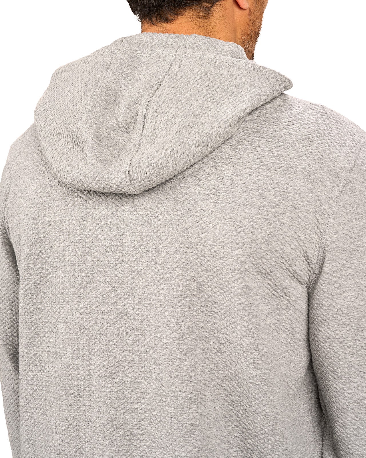 Man wearing oatmeal colored zip up hoodie from Black Clover featuring small clover icon on the left chest