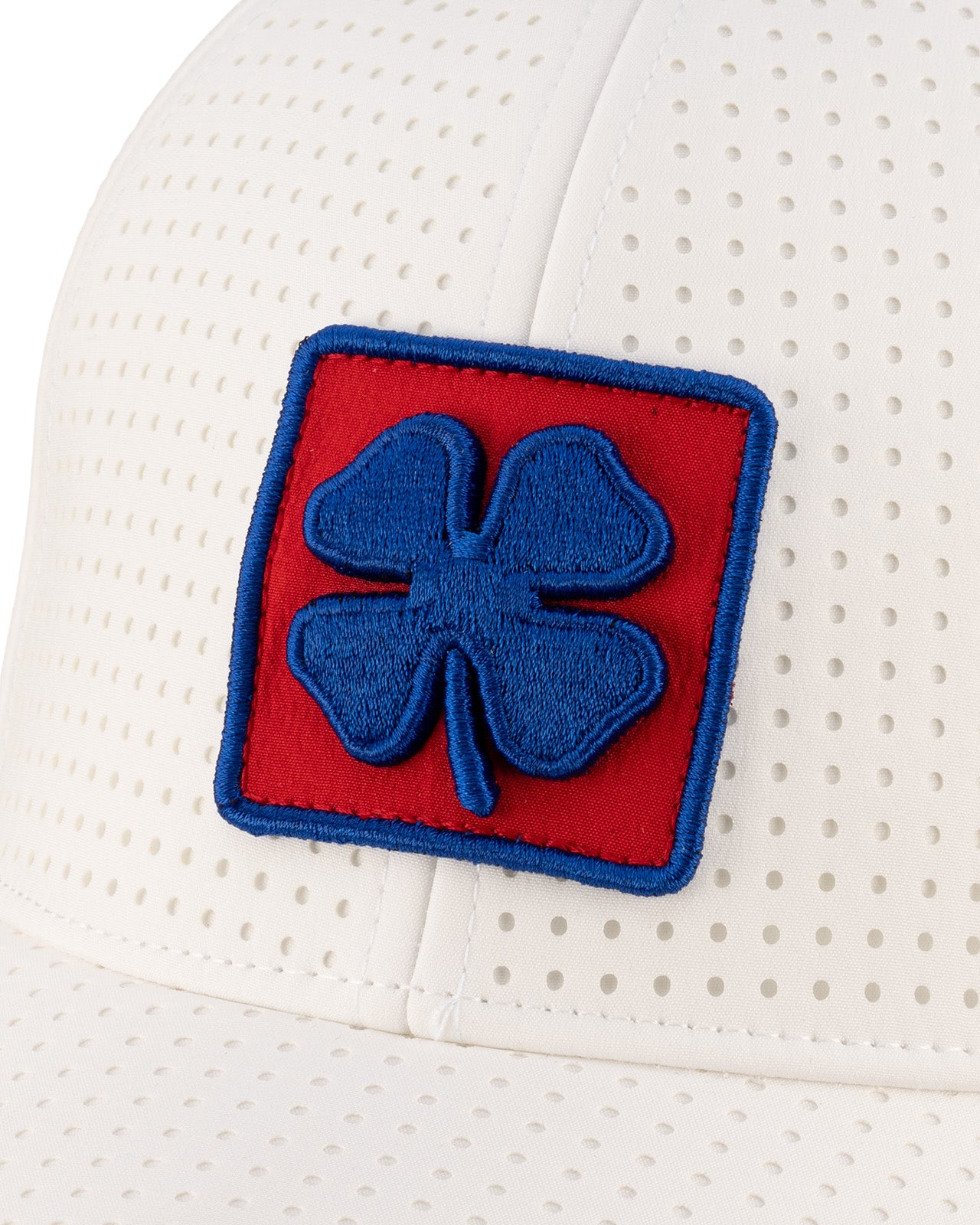 White perforated hat from Black Clover featuring the University of Kansas Jayhawks logo