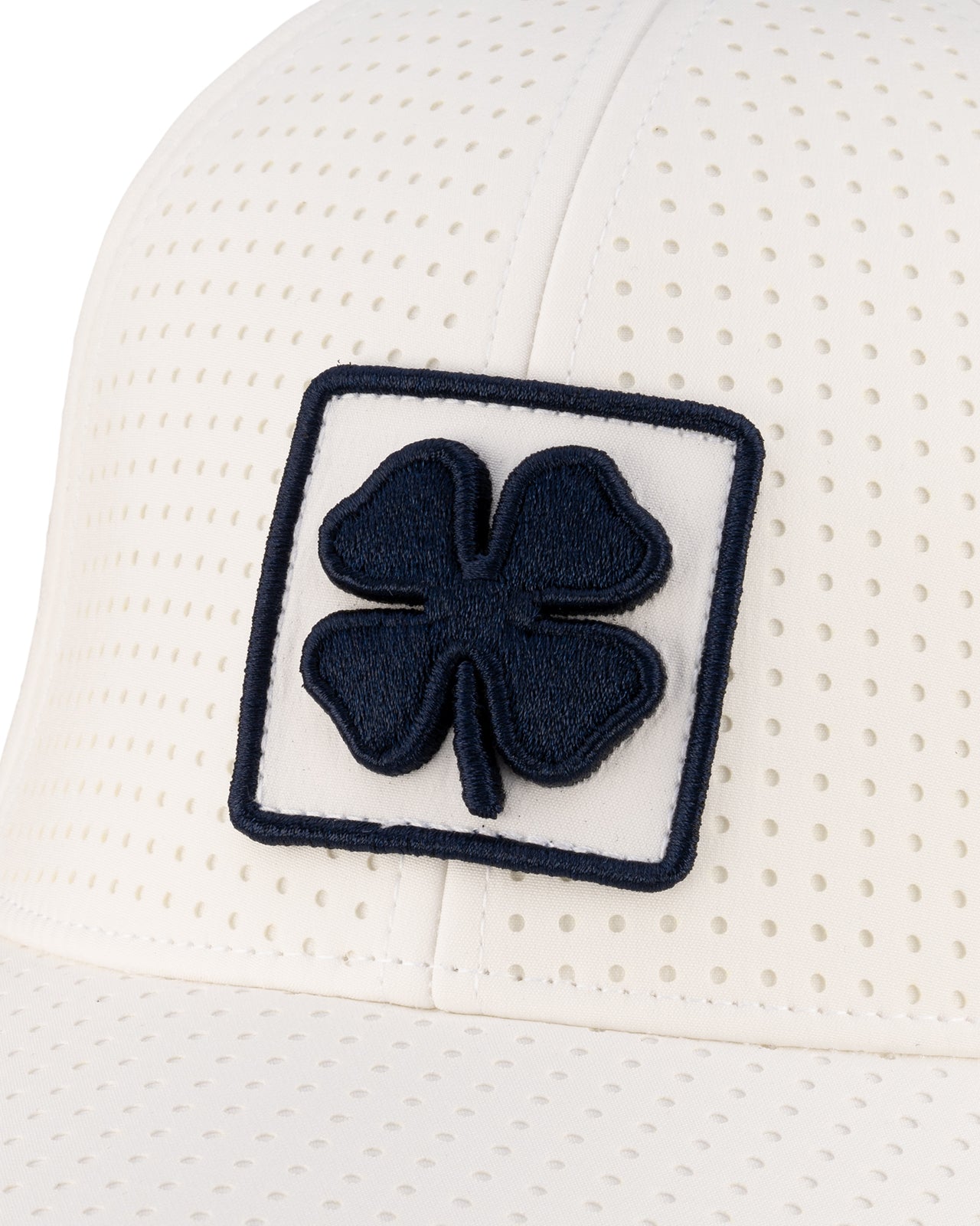 White perforated hat from Black Clover featuring University of Nevada Reno Wolfpack Logo