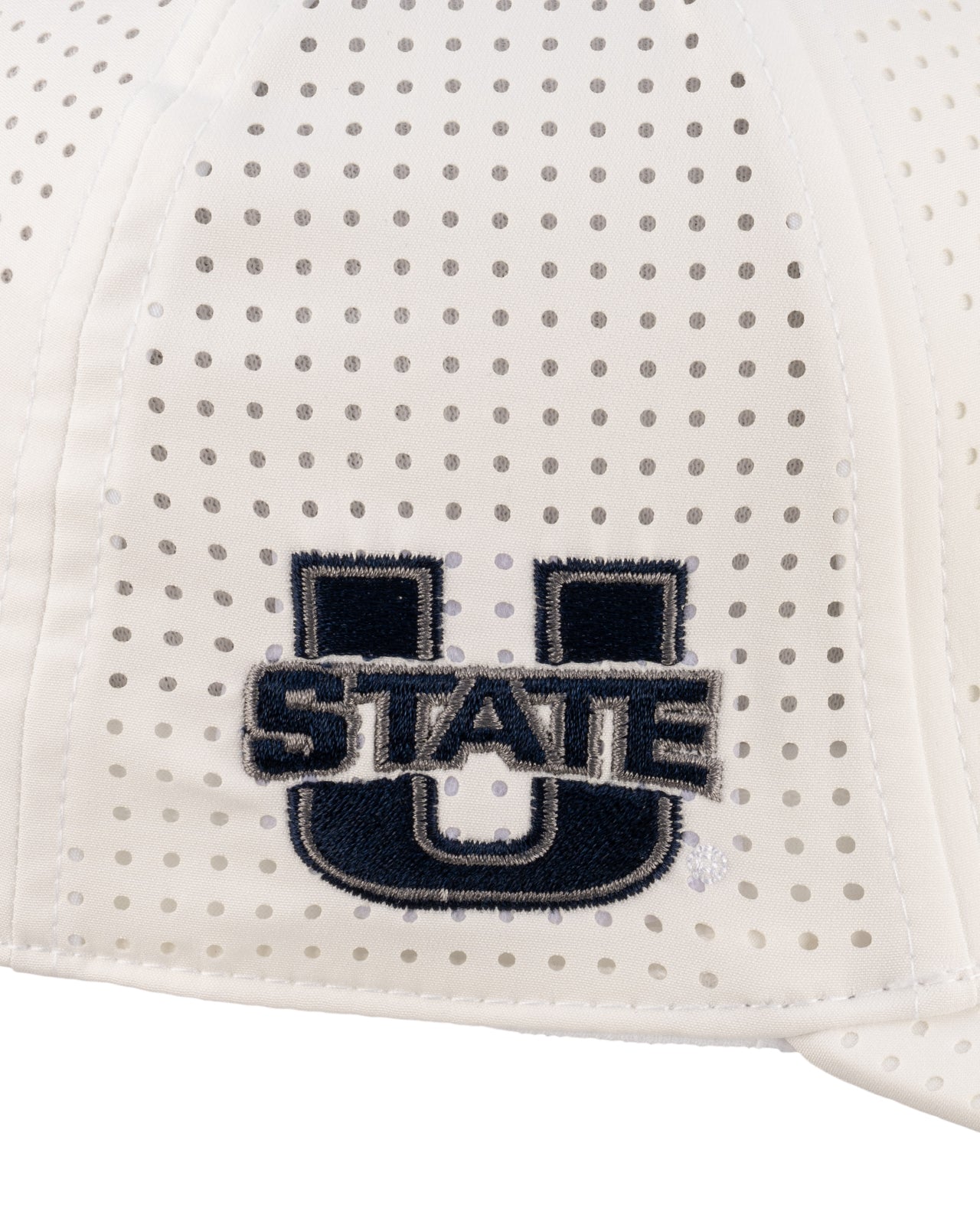 White perforated hat from Black Clover featuring USU Aggies logo